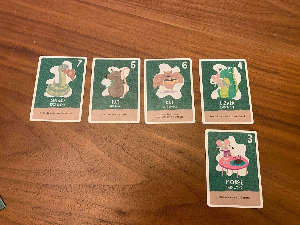 Five land creatures are arranged in 2 rows with 4 cards on the top row, and 1 card on the bottom row to the far right. They are ordered 7, 6, 5, 4 on the top. 3 on the bottom.